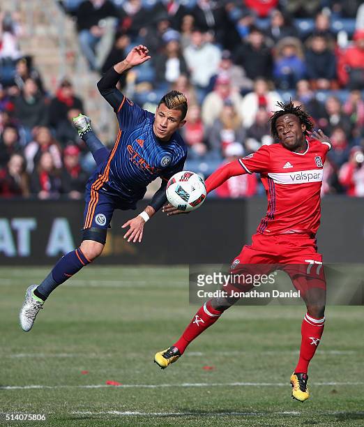 Mikey Lopez of the New York City FC and Kennedy Igboananike of Chicago Fire go airborne as they battle for the ball at Toyota Park on March 6, 2016...