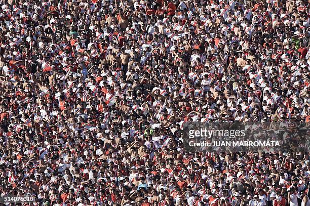 River Plate's supporters cheer for their team during the Argentine first division football match against Boca Juniors at the Monumental stadium in...