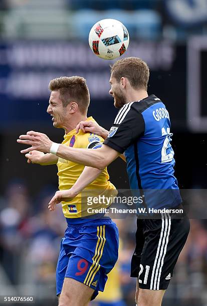 Clarence Goodson of San Jose Earthquakes hits a header over the top of Kevin Doyle of Colorado Rapids during the second half of their MLS Soccer game...