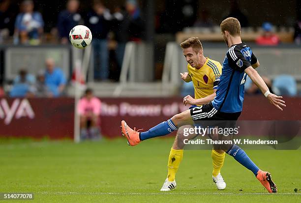 Clarence Goodson of San Jose Earthquakes kicks the ball away from Kevin Doyle of Colorado Rapids during the second half of their MLS Soccer game at...