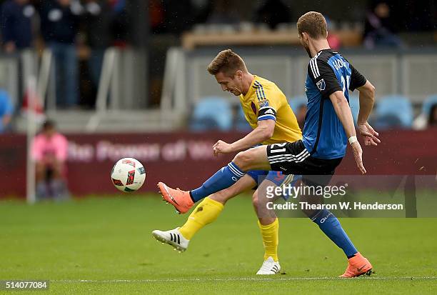 Clarence Goodson of San Jose Earthquakes kicks the ball away from Kevin Doyle of Colorado Rapids during the second half of their MLS Soccer game at...