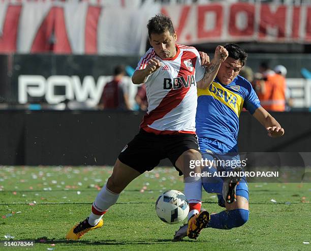 River Plate's forward Rodrigo Mora vies for the ball with Boca Juniors' defender Jonathan Silva during their Argentina First Division football match...