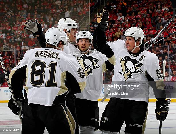 Evgeni Malkin of the Pittsburgh Penguins celebrates his goal with teammates Phil Kessel,Kris Letang and Sidney Crosby in the first period against the...