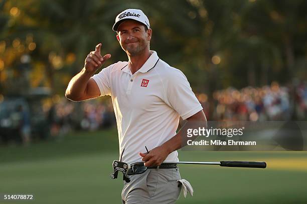 Adam Scott of Australia reacts after putting in to win on the 18th hole during the final round of the World Golf Championships-Cadillac Championship...