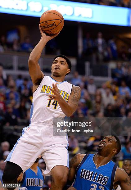 Denver Nuggets guard Gary Harris takes a shot past Dallas Mavericks guard Wesley Matthews during the first quarter March 6, 2016 at Pepsi Center.