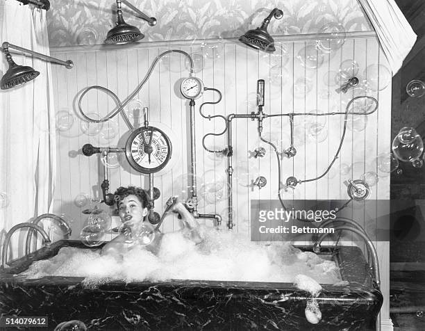 Los Angeles, California: Consider this another candidate for your "I've-seen-and-heard-everything" file. Ann Blyth, film star, taking a bubble bath...