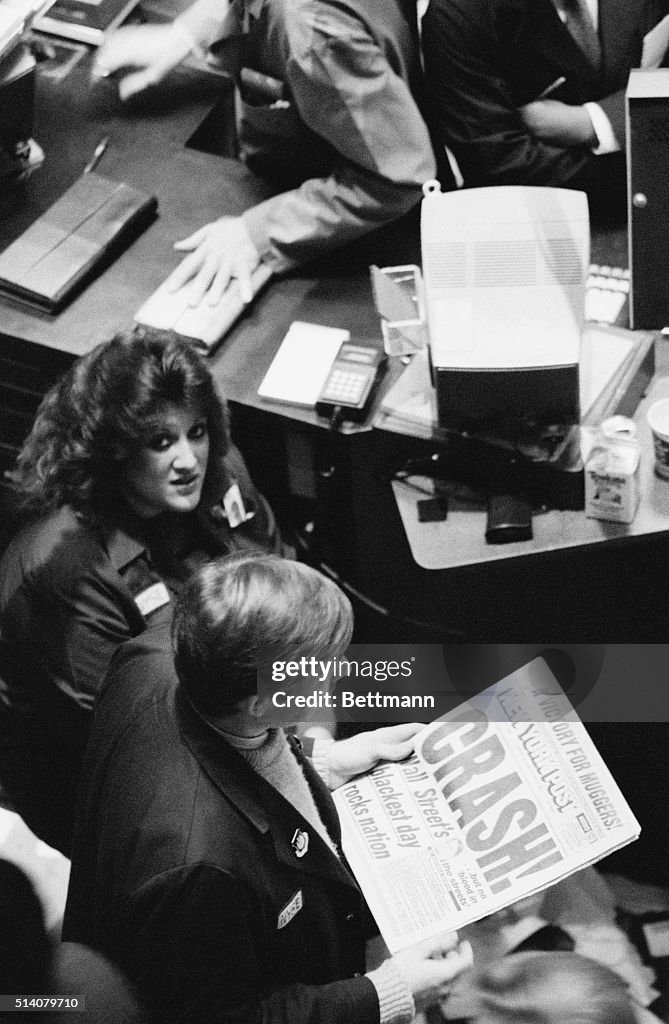 Trader On Floor Reads About Black Monday
