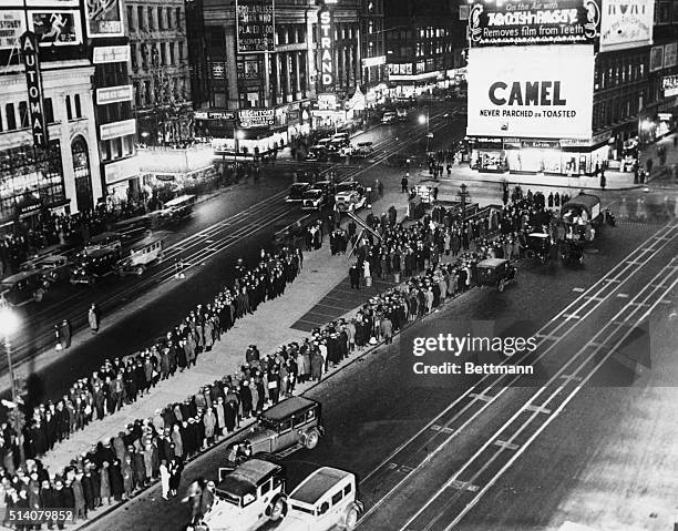 During the Great Depression, unemployed, hungry people wait in line at Times Square for rations.