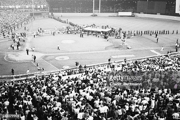 Police line the field protecting The Beatles from enthusiastic fans during a concert in Shea Stadium, New York.