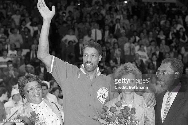 Flanked by his mother, Callie May Lindsey , and his wife, Turquoise, "Dr. J" Julius Erving of the Philadelphia 76ers waves to the crowd during...