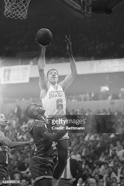 "Dr. J." Julius Erving of the Philadelphia 76ers, playing in his last regular season home game at the Spectrum before his retirement, jumps high in...