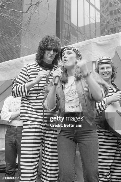 Radio talk show host Howard Stern is joined by Lisa Sliwa, wife of Guardian Angel leader Curtis Sliwa, as they address a rally in Dag Hammarskjold...