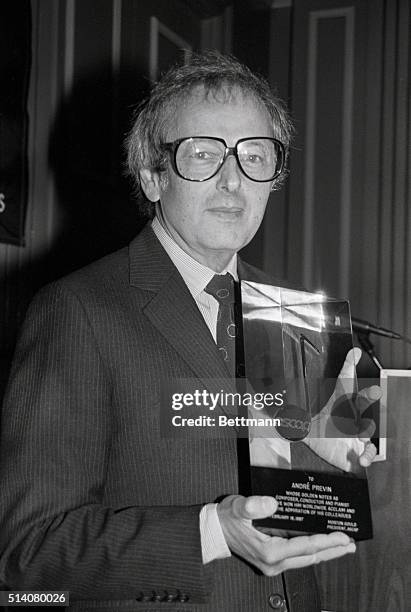 Conductor Andre Previn holds his Golden Note Award presented by the American Society of Composers, Authors, & Publishers.