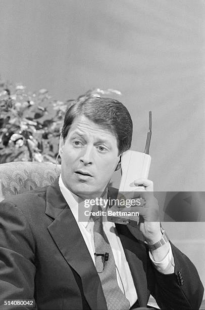 Senator Al Gore, concentrating on "Super Tuesday", the clustering in Presidental primaries in the South, uses a cellular phone to call New Hamphire...