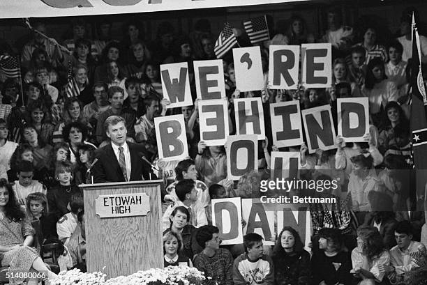 At a campaign stop in Woodstock, Georgia, Dan Quayle speaks to students at Etowah High School. The students to his rear hold signs spelling out...