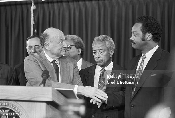 Jesse Jackson and New York Mayor Ed Koch shake hands, meeting for the first time since the Presidential primary election in New York. Manhattan...