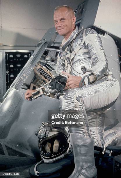 Cape Canaveral, FL-ORIGINAL CAPTION READS: Lt. Col. John Glenn, standing beside a Mercury capsule .