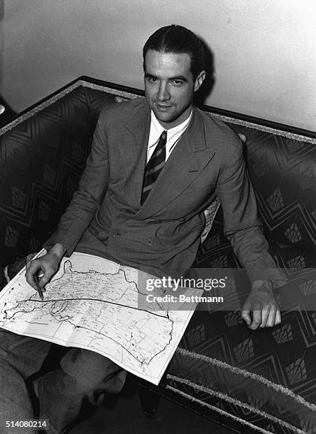 Howard Hughes shows the route he took to fly across the United States in nine hours, 27 minutes, and 10 seconds, to beat the former record set in...