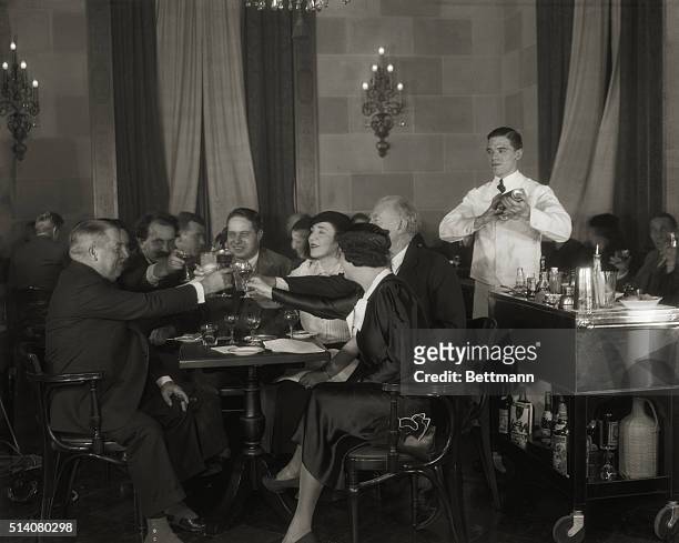 On December 4 the day before Prohibition is repealed, noted artists and writers toast the return of legal alcohol in the Park Lane Hotel in New York....