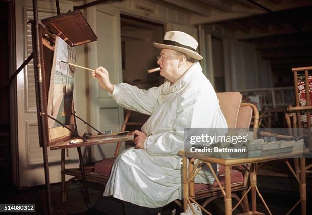 Miami Beach, FL: Winston Churchill engrossed in his hobby of oil painting at Miami Beach, FL.