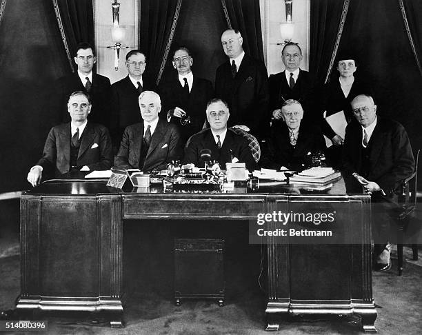 Secretary of War George H. Dern, Secretary of State Cordell Hull, President Roosevelt, Secretary of the Treasury William Hartman Woodin, and Attorney...