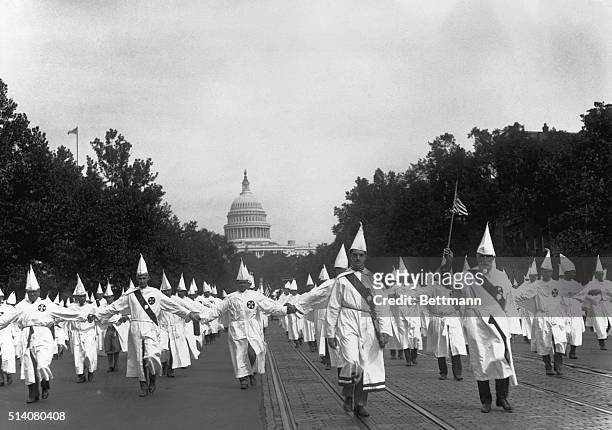 Ku Klux Klan members parade down Pennsylvania Avenue from the capitol to the treasury in Washington, DC, on August 8, 1925.