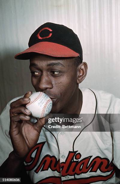 Legendary pitcher Leroy Paige, known as Satchel Paige, kisses a ball of the sport that made him famous.