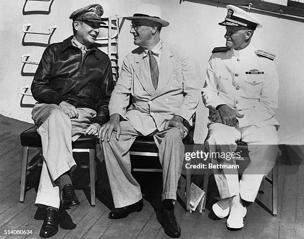 General MacArthur, President Roosevelt, and Admiral Nimitz discuss the progress of the war.