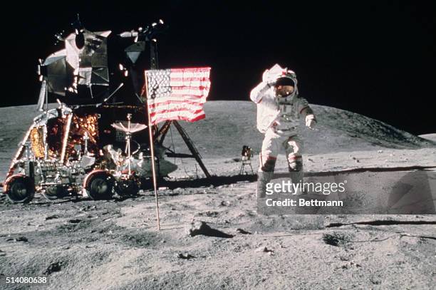 John W. Young, Commader of Apollo 16, salutes the United States Flag as he leaps from the surface of the Moon near the lunar lander. | Location:...