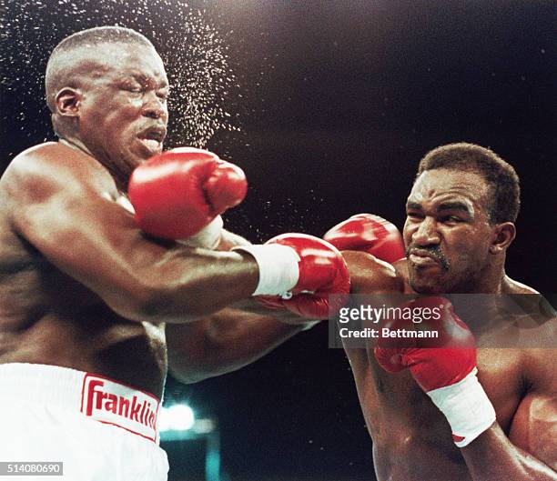 Evander Holyfield slams former heavyweight champ Buster Douglas with a right punch in the third and final round of their title fight, Las Vegas,...