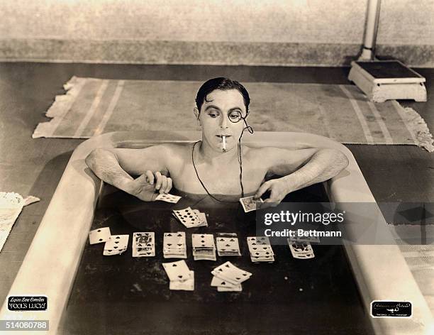 As one of the idle rich, Lupino Lane's character plays solitaire in the bathtub.