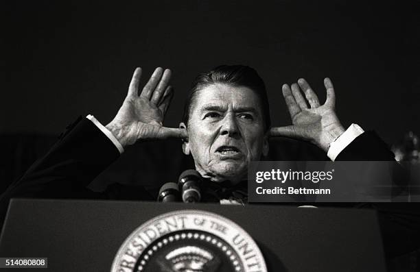 While addressing the audience at the White House News Photographers Association dinner, President Reagan said, "I've been told this is all off the...