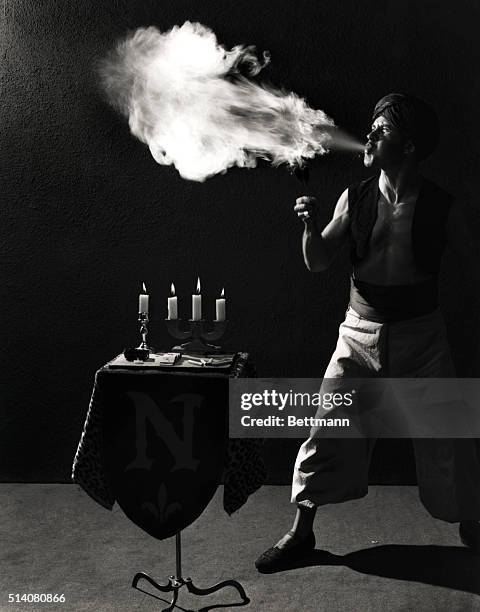 Maurice Navarre spits flame from his mouth on the set of the movie Nightmare Alley. He learned to be a fire eater while operating a flame thrower...