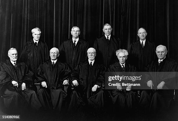 The justices of the Supreme Court. Sitting, from left to right, Justices Sutherland and McReynolds, Chief Justice Hughes, Justices Brandeis and...