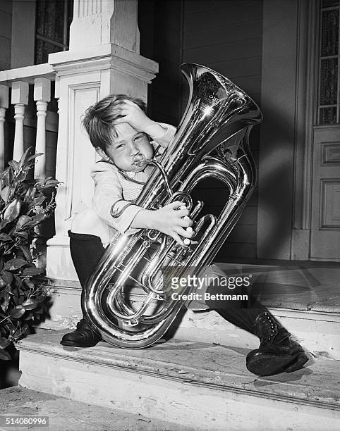 Hollywood, California: Young man with a horn Ronny Howard , just doesn't have the "oomph" to "oom-pa-pa" that big double-bell euphonium in Hollywood....
