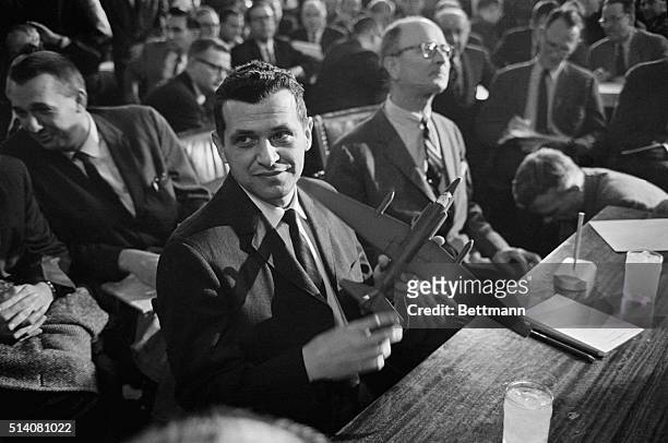 Francis Gary Powers holds a model of a U-2 spy plane as he testifies before the Senate Armed Services Committee. Powers' plane was shot down by the...