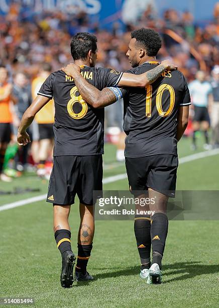 Cristian Maidana of Houston Dynamo celebrates with Giles Barnes after scoring against the New England Revolution at BBVA Compass Stadium on March 6,...
