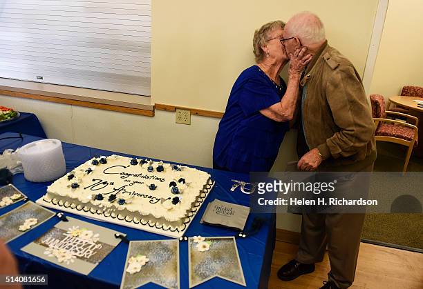 Mabel and Robert Burrows kiss after cutting their 70th wedding anniversary cake at the Broomfield Community Center on March 6, 2016 in Broomfield,...