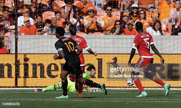 Giles Barnes of Houston Dynamo shoots past Bobby Shuttleworth of New England Revolution to score in the second half as Je-Vaughan Watson of the...