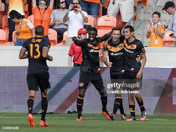 Andrew Wenger of Houston Dynamo celebrates with Cristian Maidana, Jalil Anibaba and Ricardo Clark after scoring against the New England Revolution at...