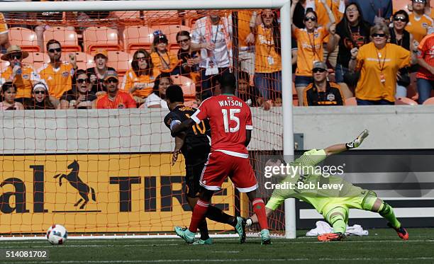 Bobby Shuttleworth of New England Revolution watches the ball enter the net off a shot by Andrew Wenger of Houston Dynamo as Dynamo teammate...