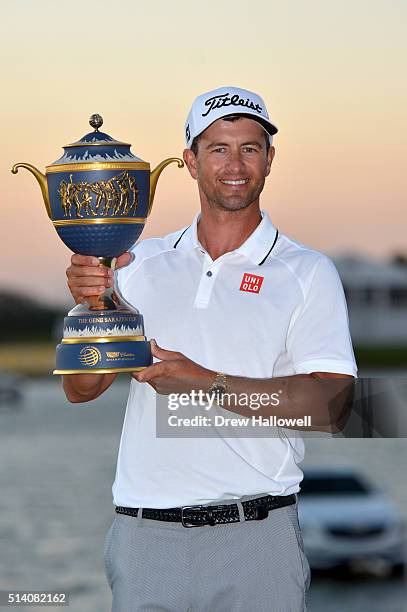 Adam Scott of Australia poses with the trophy on the 18th hole during the final round of the World Golf Championships-Cadillac Championship at Trump...