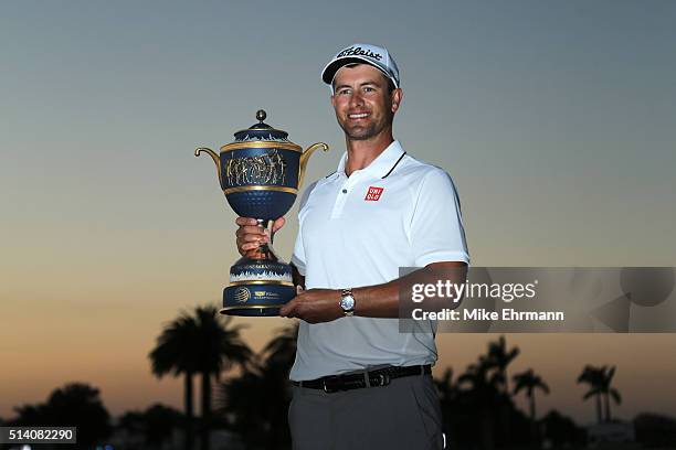 Adam Scott of Australia poses with the trophy on the 18th hole during the final round of the World Golf Championships-Cadillac Championship at Trump...