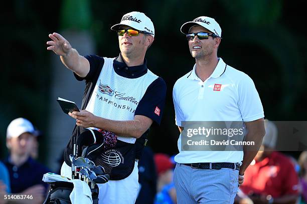 Adam Scott of Australia with his caddie David Clark on the tee at the par 4, 16th hole during the final round of the World Golf...