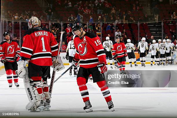 Tyler Kennedy,Keith Kinkaid and Travis Zajac of the New Jersey Devils skate off the ice as the Pittsburgh Penguins celebrate the win on March 6, 2016...