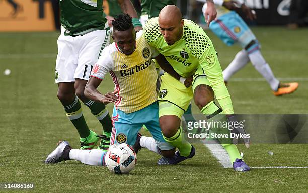 Harrison Afful of Columbus Crew and Adam Larsen Kwarasey of Portland Timbers go after a ball during the second half of the game at Providence Park on...