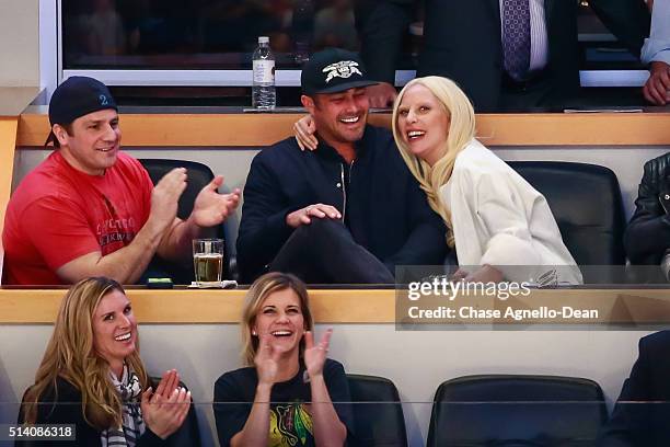 Actor Taylor Kinney and musician Lady Gaga enjoy watching the NHL game between the Chicago Blackhawks and the Detroit Red Wings at the United Center...