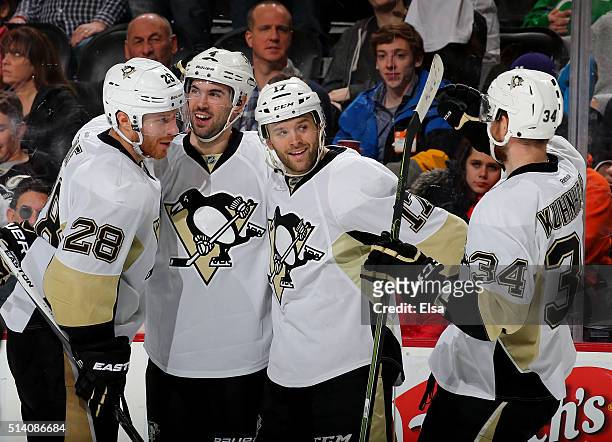 Ian Cole,Justin Schultz and Tom Kuhnhackl of the Pittsburgh Penguins congratulate teamamte Bryan Rust after he scored in the third period against the...