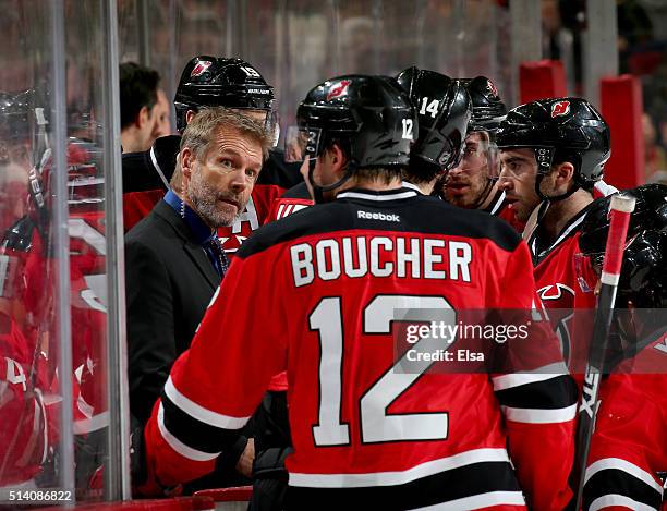 Assistant coach Geoff Ward of the New Jersey Devils talks with Reid Boucher,Adam Henrique and Kyle Palmieri during a stop in play against the...