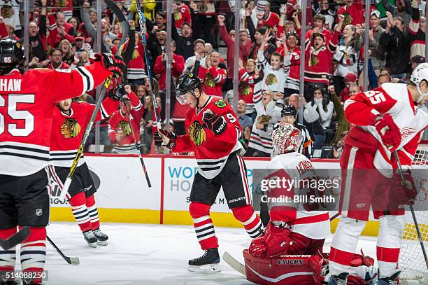 Jonathan Toews of the Chicago Blackhawks reacts after scoring on goalie Jimmy Howard of the Detroit Red Wings in the third period of the NHL game at...